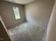 A bedroom with bare concrete floors and neutral paint at 311 W Market St, Graham, NC 27253