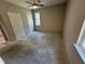 A bedroom with bare concrete floors, neutral paint, and a ceiling fan at 311 W Market St, Graham, NC 27253