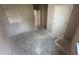 A bedroom with bare concrete floors and neutral paint at 311 W Market St, Graham, NC 27253