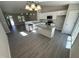 Open concept kitchen with island, stainless steel appliances and open to the living area at 311 W Market St, Graham, NC 27253