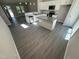 Open kitchen with modern white cabinetry, island, and stainless steel appliances at 311 W Market St, Graham, NC 27253