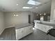 Open kitchen area featuring a center island, stainless appliances, and modern finishes at 311 W Market St, Graham, NC 27253
