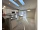 Bright kitchen featuring granite countertops and skylights over the dining area at 311 W Market St, Graham, NC 27253