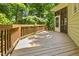 Wooden back deck with wooden railings and access to the backyard through a door at 3124 Briar Stream Run, Raleigh, NC 27612