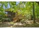 A beautiful wooden deck and screened-in porch offer a serene view of the lush, shaded backyard at 3124 Briar Stream Run, Raleigh, NC 27612