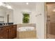 Bathroom with soaking tub, shower, granite vanity and window views at 3124 Briar Stream Run, Raleigh, NC 27612