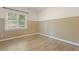 Bedroom featuring a chair rail, hardwood floors and a window at 3124 Briar Stream Run, Raleigh, NC 27612