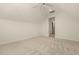Bedroom with neutral carpet, white walls, a ceiling fan, an attic access door, and an entryway at 3124 Briar Stream Run, Raleigh, NC 27612
