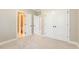 Bedroom with carpet, double closets and view to the bathroom at 3124 Briar Stream Run, Raleigh, NC 27612
