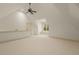 Bonus room with light carpet, white walls, a ceiling fan, attic access, and window nook at 3124 Briar Stream Run, Raleigh, NC 27612