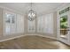Bright dining room with plantation shutters, hardwood floors, and elegant chandelier at 3124 Briar Stream Run, Raleigh, NC 27612