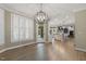 Open dining area with chandelier, hardwood floors, and easy flow into the kitchen at 3124 Briar Stream Run, Raleigh, NC 27612