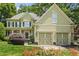 Charming two-story home with a well-manicured lawn and two-car garage, surrounded by lush greenery at 3124 Briar Stream Run, Raleigh, NC 27612