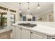 Open-concept kitchen with granite countertops, white cabinets, and seamless flow to the living area at 3124 Briar Stream Run, Raleigh, NC 27612