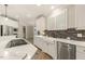 Spacious kitchen with stainless steel appliances, white cabinets, and stylish backsplash at 3124 Briar Stream Run, Raleigh, NC 27612