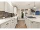 Well-equipped kitchen with white cabinets, quartz countertops, and access to the outdoor deck at 3124 Briar Stream Run, Raleigh, NC 27612