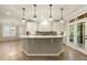 Modern kitchen with a large island, pendant lighting, and stainless steel appliances at 3124 Briar Stream Run, Raleigh, NC 27612