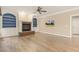 Hardwood floors span this large living room complete with a brick fireplace, ceiling fan and built-in bookcases at 3124 Briar Stream Run, Raleigh, NC 27612