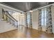 Spacious living room with dark ceiling, statement lighting, staircase, and hardwood floors at 3124 Briar Stream Run, Raleigh, NC 27612