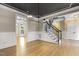 Living room with hardwood floors, stairs, and elegant trim at 3124 Briar Stream Run, Raleigh, NC 27612