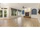 Large living room featuring a brick fireplace, ceiling fan, built-in bookcases, hardwood floors and natural light at 3124 Briar Stream Run, Raleigh, NC 27612