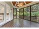 Back screened-in porch featuring a decorative ceiling and fan, and backyard views at 3124 Briar Stream Run, Raleigh, NC 27612