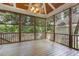 Screened-in back porch with a ceiling fan, a wood floor, and views of the wooded backyard at 3124 Briar Stream Run, Raleigh, NC 27612