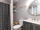 Stylish bathroom featuring a patterned shower curtain, vanity, and round mirror at 3600 Star Trek Ct, Raleigh, NC 27604