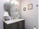Bathroom features a modern vanity with a round mirror and brushed nickel fixtures at 3600 Star Trek Ct, Raleigh, NC 27604
