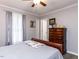 Bedroom with hardwood floors, ceiling fan, and wooden dresser at 3600 Star Trek Ct, Raleigh, NC 27604
