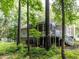 Exterior view of the home with a screened porch and lush green backyard landscape at 3600 Star Trek Ct, Raleigh, NC 27604