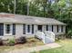 Charming ranch-style home with neutral siding, black shutters, and a welcoming white railing entryway at 3600 Star Trek Ct, Raleigh, NC 27604