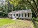 Charming single story home with black shutters surrounded by a forest landscape at 3600 Star Trek Ct, Raleigh, NC 27604
