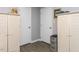 Neutral-toned hallway showcases two closet doors and wood floors, offering ample storage at 3600 Star Trek Ct, Raleigh, NC 27604