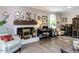 Well-lit living room boasts wood floors, a fireplace and stylish furnishings at 3600 Star Trek Ct, Raleigh, NC 27604