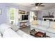 Cozy living room with neutral tones, a ceiling fan, and great natural light at 3600 Star Trek Ct, Raleigh, NC 27604