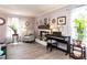 Airy living room with natural light, wood floors, fireplace, and a piano at 3600 Star Trek Ct, Raleigh, NC 27604