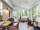 Inviting screened porch features comfortable seating and views of the wooded backyard at 3600 Star Trek Ct, Raleigh, NC 27604