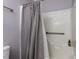 Shower stall featuring a gray shower curtain and safety bar for convenience at 3600 Star Trek Ct, Raleigh, NC 27604
