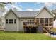 Charming back exterior featuring a wooden deck, outdoor storage, and an inviting screened-in porch at 40 Yellowstone Ct, Youngsville, NC 27596