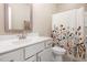 Bright bathroom featuring a floral shower curtain, neutral paint and ample natural light at 40 Yellowstone Ct, Youngsville, NC 27596