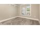 A bright bedroom with soft carpet and a window that provides natural light and views of the surrounding area at 40 Yellowstone Ct, Youngsville, NC 27596