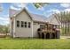 Back exterior of the home featuring a deck, fenced-in yard, and mature landscaping at 40 Yellowstone Ct, Youngsville, NC 27596