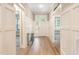 Bright foyer with hardwood floors, white wainscoting, and a glass-paneled front door at 40 Yellowstone Ct, Youngsville, NC 27596