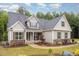 Beautiful home exterior showcases stone accents, covered porch, and mature landscaping at 40 Yellowstone Ct, Youngsville, NC 27596