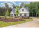 Charming home with a well-manicured lawn, lush landscaping, and a paved driveway at 40 Yellowstone Ct, Youngsville, NC 27596