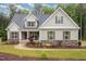 Charming home with a stone accent base, lush landscaping, and a cozy front porch at 40 Yellowstone Ct, Youngsville, NC 27596