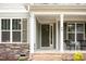 Welcoming front porch with seating area, stylish door, and stone accents at 40 Yellowstone Ct, Youngsville, NC 27596