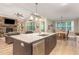 Open-concept kitchen with granite island, stainless steel dishwasher, and a view of the living room and dining area at 40 Yellowstone Ct, Youngsville, NC 27596