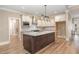 Bright kitchen with white cabinets, stainless steel appliances, and a large center island with granite countertops at 40 Yellowstone Ct, Youngsville, NC 27596